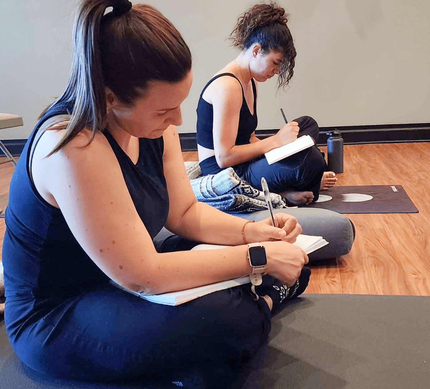 Yoga Teacher Training students writing notes at The Mind-Body Connection